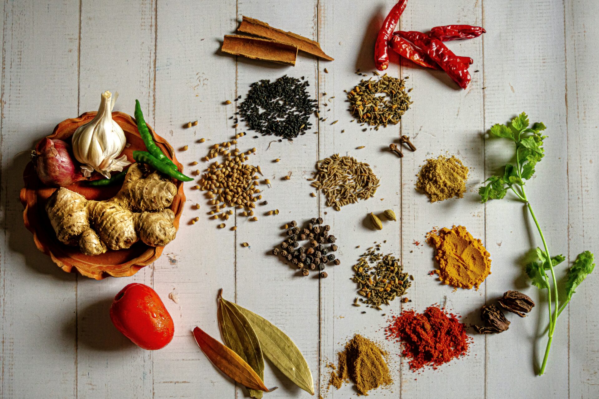 a variety of spices on a white table