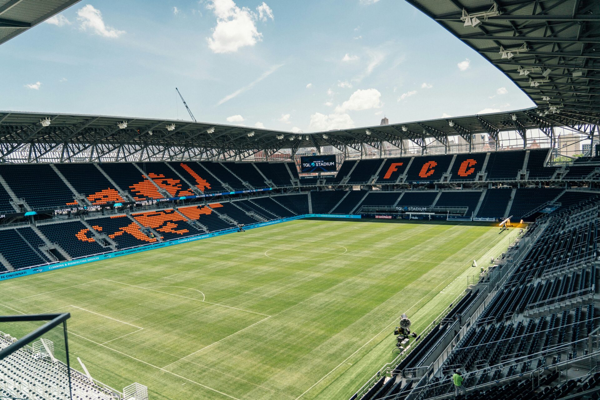 an empty soccer stadium with a green field