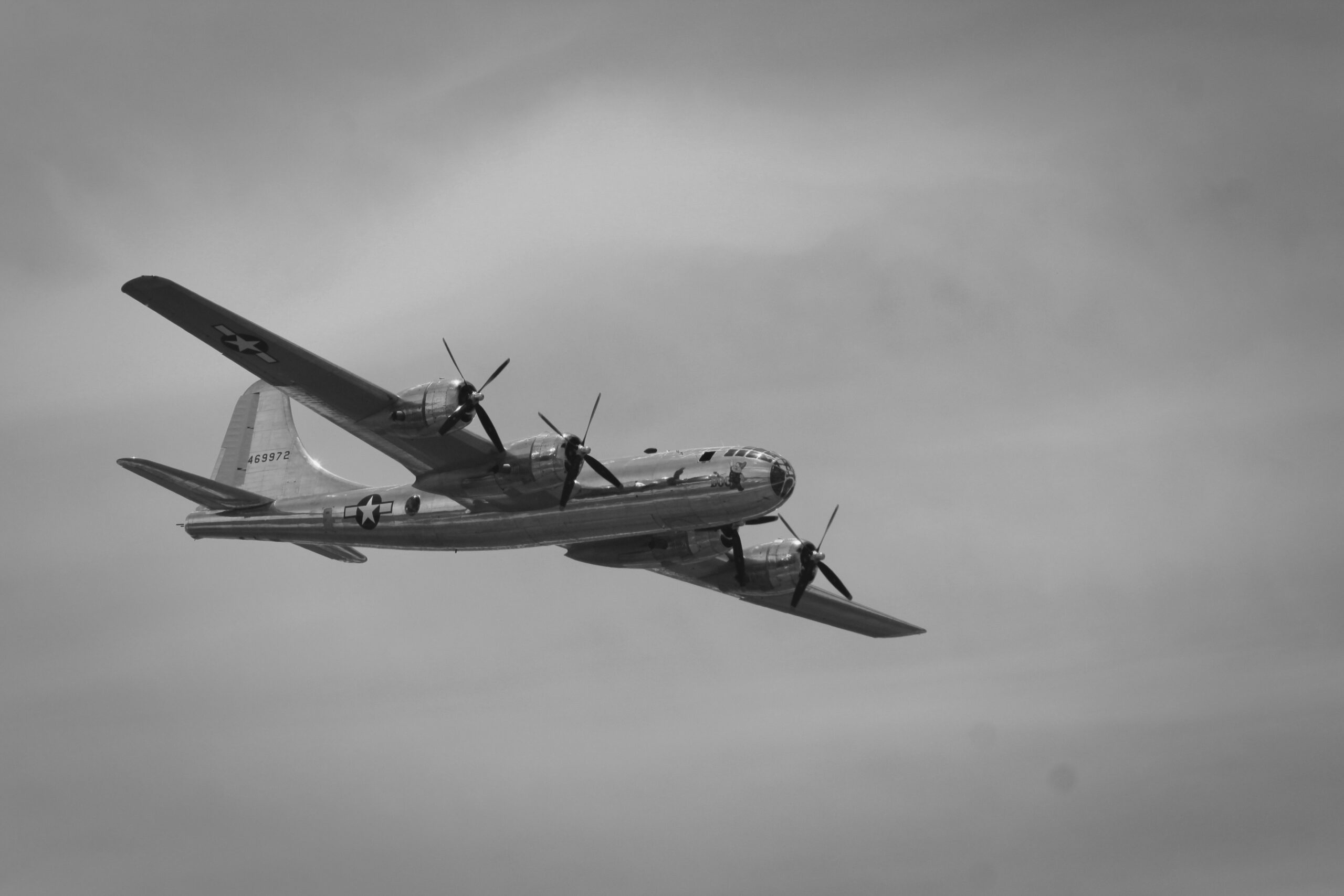 grayscale photography of flying plane scaled 1