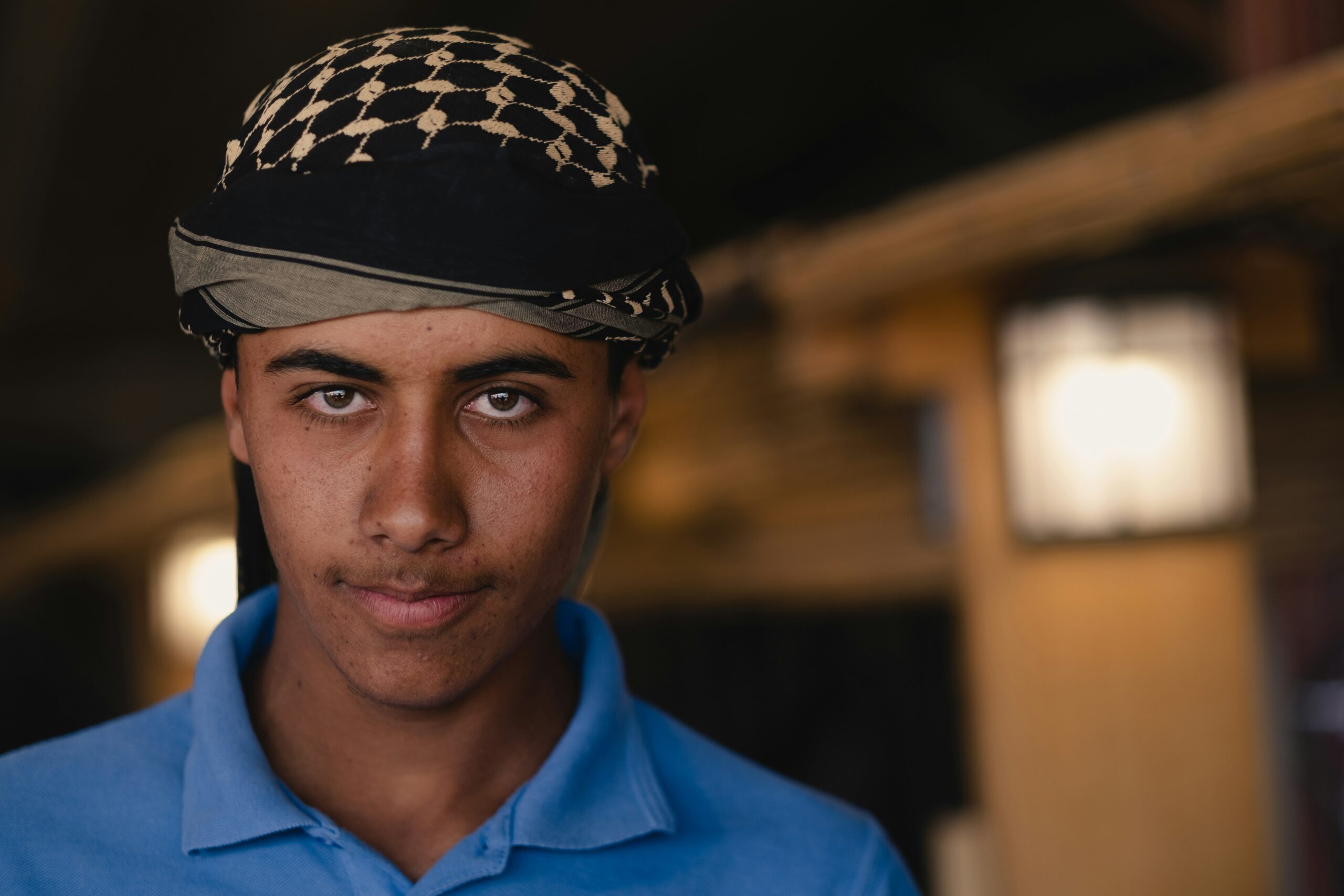 man in blue polo shirt wearing black and white hat