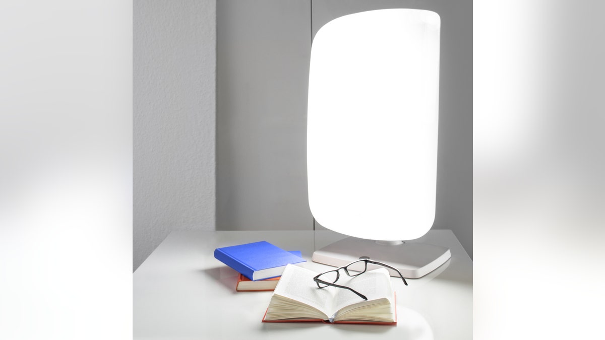 light therapy lamps, SAD, Seasonal Affective Disorder, winter blues, depression, mood boosting, energy levels, sleep regulation, appetite regulation, self-care, Verilux HappyLight Luxe, Circadian Optics, Carex Day-Light Classic Plus, Aura lamp, Philips SmartSleep, Boxelite lamp, Lumie Vitamin L, Beurer, NorthStar 10,000, DNA Vibe Jazz Band, blue light glasses, portable light therapy, 10000 lux, UV-free light, light therapy deals, wellness, winter wellness, wake-up light, light therapy benefits, infrared light therapy, pain relief, inflammation, light therapy for injury recovery.
