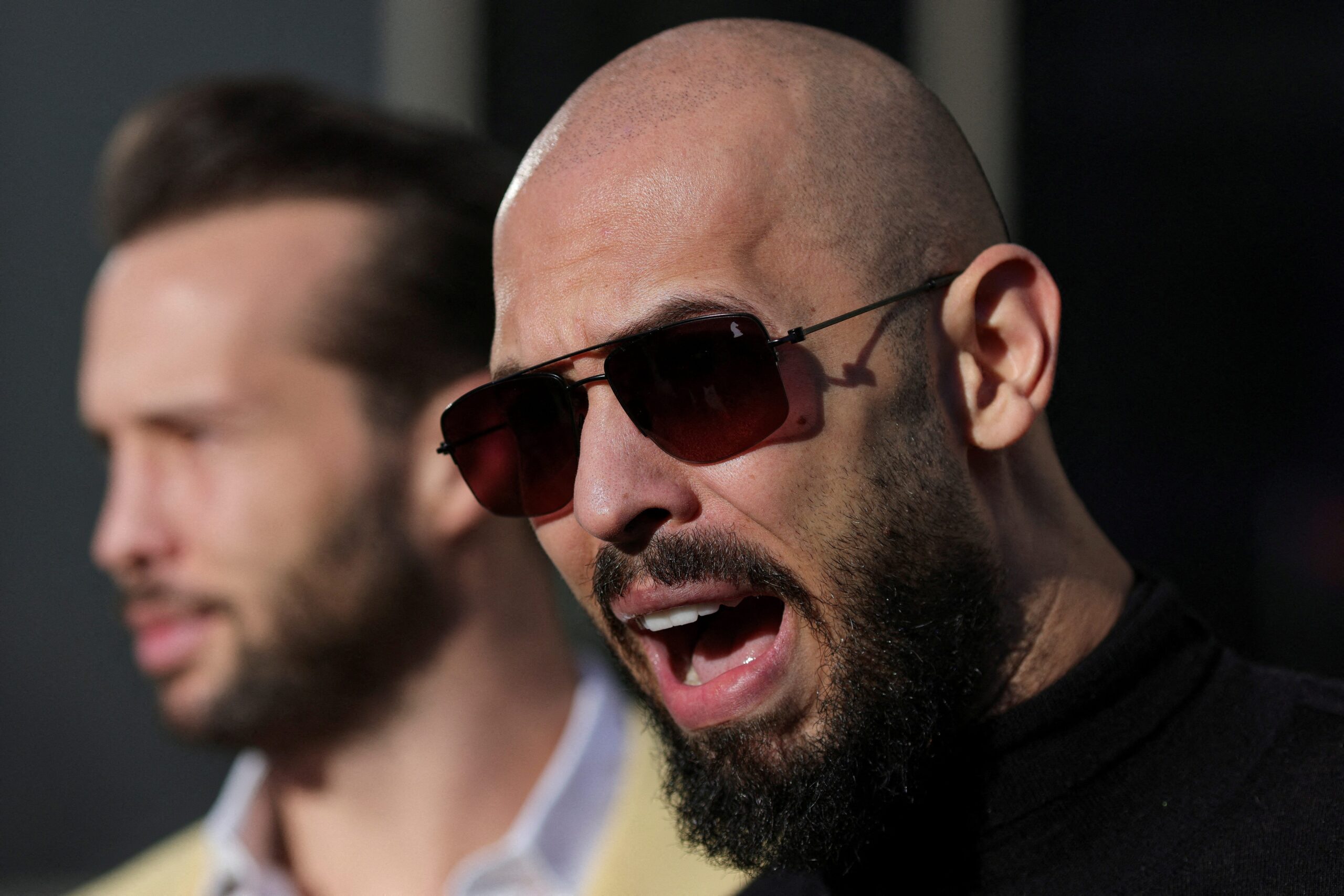 Andrew Tate, Tristan Tate, Romania, Human Trafficking, Sexual Assault, Money Laundering, Travel Ban, Florida, Extradition, United Kingdom, Criminal Investigation, Donald Trump, Richard Grenell, Misogyny, Social Media Influencer, Arrest Warrant, Judicial Control
