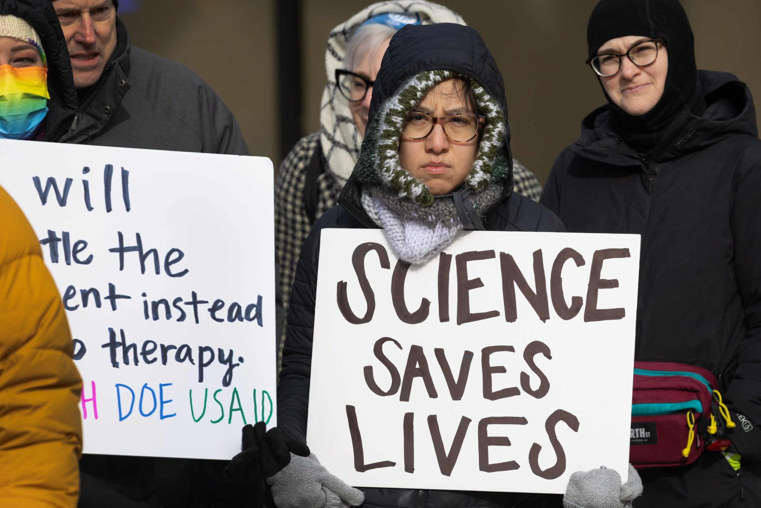 NIH funding cuts, Trump administration, research grants, universities, Democratic states, Judge Angel Kelley, injunction, medical research, clinical trials, indirect costs, federal spending, layoffs, lab closures, scientific studies, National Institutes of Health, Harvard, Yale, Johns Hopkins, endowments, U.S. Justice Department, congressional legislation

