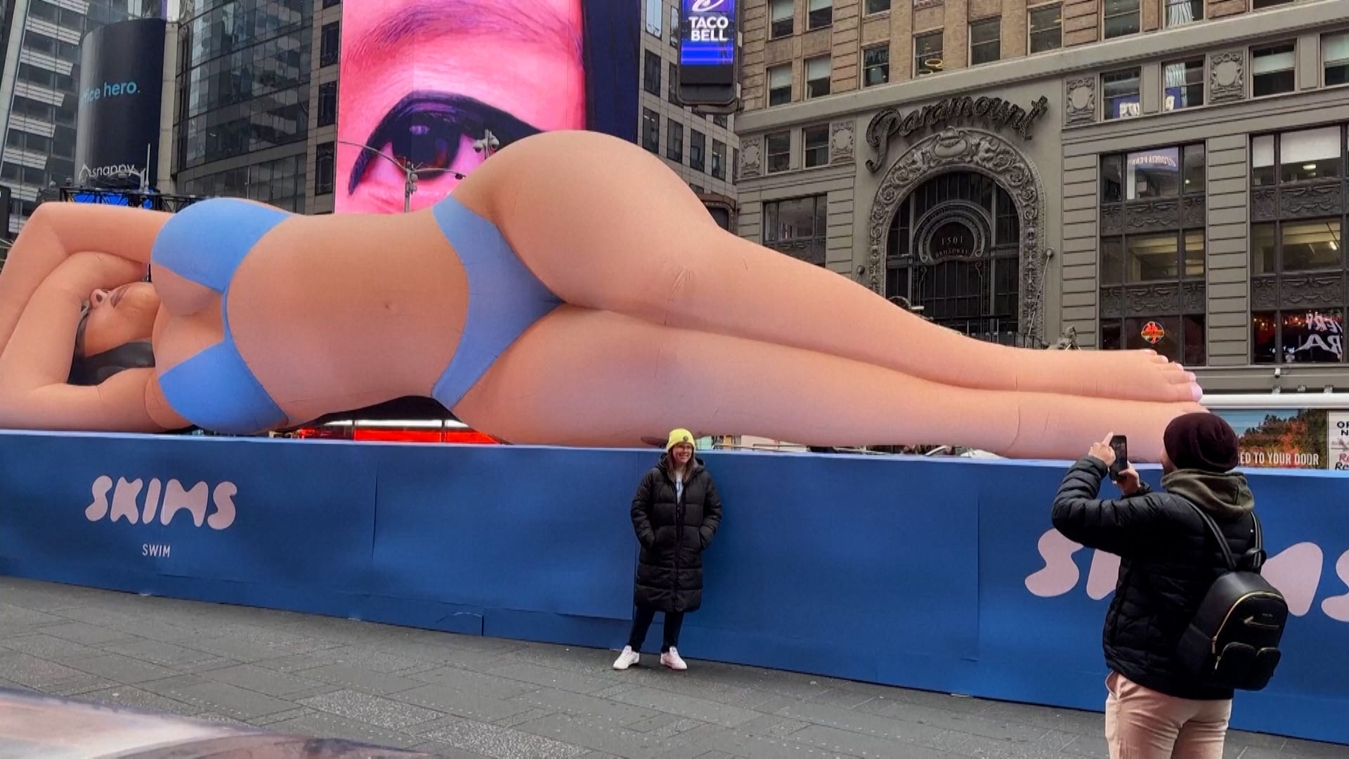 Kim Kardashian, Skims, inflatable, swimwear, Times Square, marketing, body image, social media, online reactions, new collection, swimsuits, shapewear, Kim-flatable, celebrity, fashion.
