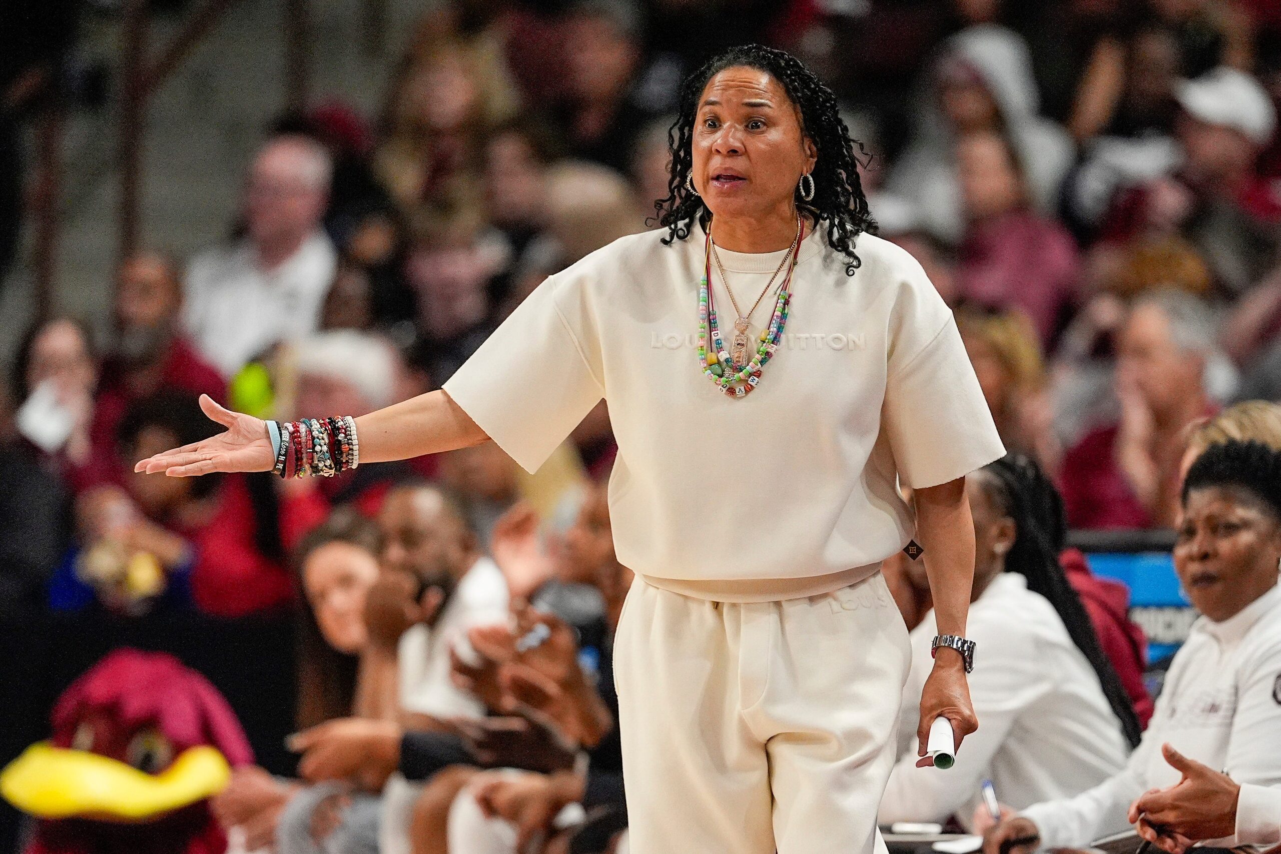 Dawn Staley, South Carolina Gamecocks, March Madness, NCAA Tournament, women's basketball, fashion, Louis Vuitton, Gucci, luxury brands, coach outfits, game day style, Plies, national championship trophy, jewelry, cream outfit, Colonial Life Arena, Columbia South Carolina
