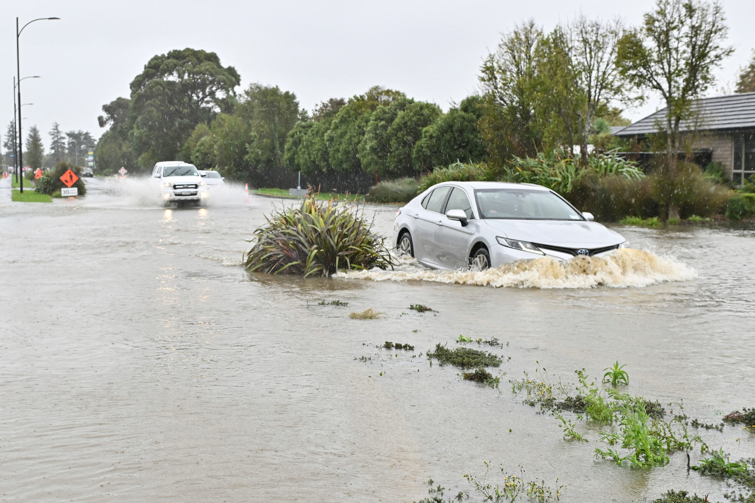 Wellington, New Zealand, flooding, red weather alert, severe weather, heavy rain, school closures, flight cancellations, power outage, North Island, South Island, MetService, wind speed, weather record, natural disaster
