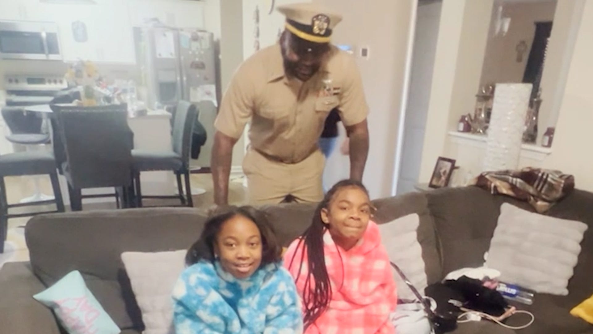 Military family reunion, Navy father surprise, San Diego reunion, emotional reunion, sisters surprise, long distance family, Quiyon Young, Laila Young, Laci Young, military family, heartwarming video, family separation, overseas assignment
