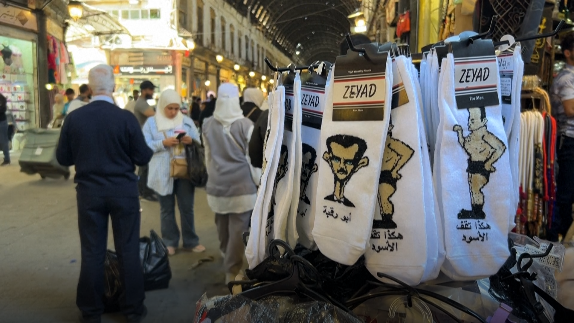 Syria, Bashar al-Assad, socks, political satire, Damascus, Ziad Zaouit, Maher al-Assad, Captagon, regime change, political merchandise, anti-Assad, Syrian economy, humor, protest, viral marketing, souvenirs, Middle East politics, political commentary
